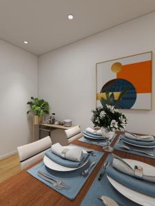 a dining room with a table with plates and napkins at Nomads Nook in London
