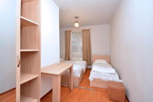 a small room with two beds and a desk at Charents 4 Guest house in Yerevan