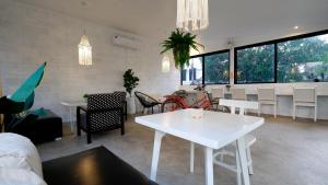 a living room with a white table and chairs at Hotel MAMI Resort in Amphoe Koh Samui