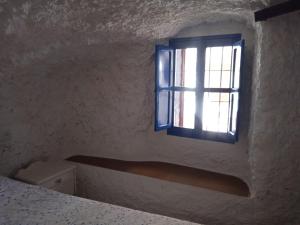 Ένα ή περισσότερα κρεβάτια σε δωμάτιο στο Casa cueva Las Yucas