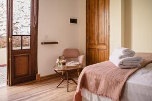 a bedroom with a bed and a table with towels at La Noire Petit hotel in Buenos Aires
