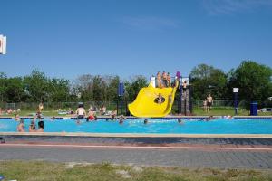 a group of people in a pool at a water park at Safari lodge in Petten