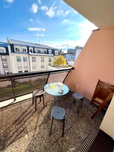 a balcony with a table and chairs on a building at Appartement Cosy & Spacieux - Centre ville in Strasbourg