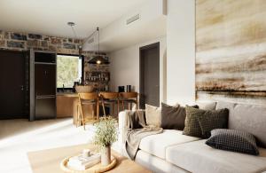 a living room with a couch and a kitchen at Volta Seaside Boutique Hotel in Kokkíni Khánion