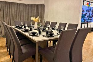 a table with chairs and wine glasses on it at 25P Muji Black & White Kajang Villa with 100" TV in Bandar Baru Bangi +102 photos