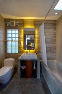 a bathroom with a sink and a tub and a toilet at Luxury Villas in Munduk at walking distance to Tamblingan Lake in Munduk +25 photos