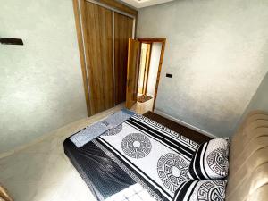 a bedroom with a bed with a large mirror at Modern and quiet apartment in Beni Mellal +6 photos