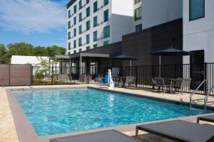 a swimming pool in front of a building at Courtyard by Marriott Lake City in Lake City