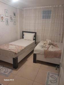 two twin beds in a room with a window at Fatih simge in Istanbul