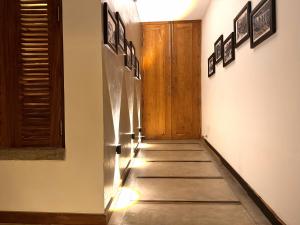 a hallway with a stainless steel refrigerator in a room at SereneVbes - Kandy in Kandy +33 photos