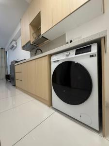 a kitchen with a white dishwasher in a kitchen at Majestic Residence Klcc by Like Home in Kuala Lumpur