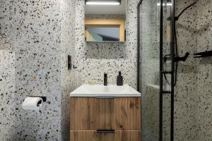 a bathroom with a sink and a shower at Homewell Premium Lofts - free parking in Poznań +16 photos
