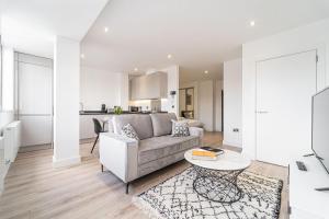 a living room with a couch and a table at Contemporary Studio near NEC & Airport Free Parking in Olton +19 photos