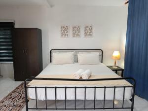 a bedroom with a bed with two towels on it at Zainab Cottage in Pasir Puteh