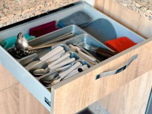 a drawer filled with utensils in a kitchen at Modern and quiet apartment in Beni Mellal