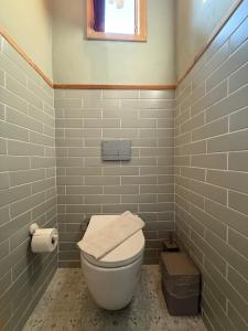 a bathroom with a white toilet and a window at With the comfort of home in Kemer +47 photos