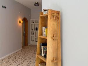 a book shelf against a wall with books at With the comfort of home in Kemer