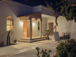 a front porch of a house with a table and chairs at With the comfort of home in Kemer