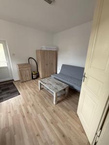 a bedroom with a bed and a table and a door at Centrum Brezno in Brezno