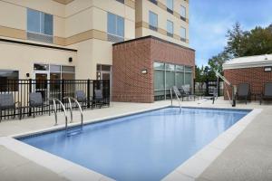 a swimming pool in front of a building at Fairfield Inn & Suites Weldon in Weldon