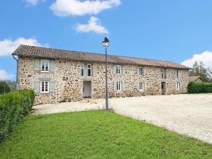 a stone building with a street light in front of it at Gîte Les Champs N°3 in Saint-Mathieu