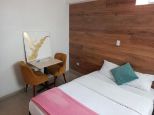 a hotel room with a bed and a table with a desk at HOTEL CUSCO PERU in Cusco