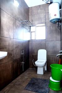 a bathroom with a toilet and a sink at Shakthi Homestay in Sringeri