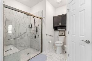 a white bathroom with a shower and a toilet at NEW Temple House - 12PPL - Families, Groups, Insurance - Quiet Street, 5 Mi To Meta, BS&W, UMHB Pets OK, FAST Wi-Fi FREE Parking - Professionally Managed By Stay Albatross Furnished Rentals in Temple