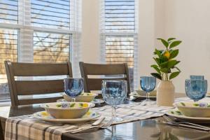 a dining room table with plates and glasses on it at NEW Temple House - 12PPL - Families, Groups, Insurance - Quiet Street, 5 Mi To Meta, BS&W, UMHB Pets OK, FAST Wi-Fi FREE Parking - Professionally Managed By Stay Albatross Furnished Rentals in Temple +28 photos