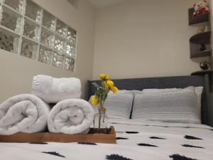 a room with a bed with towels on it at Serenity Escape in Hudson Valley in Hopewell Junction