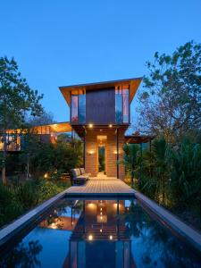 a house with a pool in front of it at Taru Villas Maia - Habarana in Habarana
