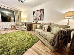 a living room with a couch and a green rug at Secluded Hot Tub, With Views - Abergavenny in Abergavenny