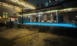 a swimming pool in a building at night at The Century Hostel George Town 乔治市世纪青旅 in George Town