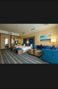 a large hotel room with a bed and a couch at Hayat Plus Hotel in Al Madinah