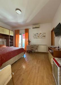 a bedroom with a bed and a table in a room at Rooms Mimi in Krk