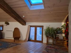 a living room with wooden ceilings and a skylight at Gîte dans La circulade - Le Pouget in Le Pouget