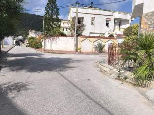 an empty street in front of a white house at Bizerte Tunisia cozy studio in Bizerte
