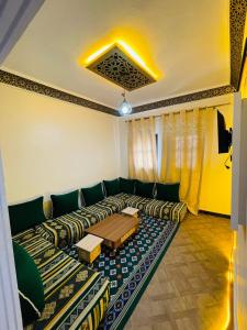 a living room with a couch and a table at Luxury apartment in Laayoune in Oulad el Haj