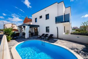 a villa with a swimming pool and a house at Villa Essenza Rossa in Vodice only 650 meters from the beach in Vodice +45 photos