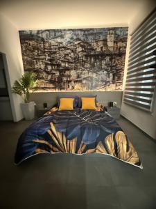 a bedroom with a large bed with a painting on the wall at Suite degli Archi - Genova Fronte Acquario in Genova