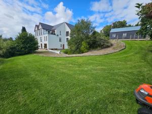 ein Haus mit einem grünen Rasen davor in der Unterkunft River Cottage - Causeway Coast - Coleraine in Fish Loughan