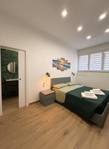 a bedroom with a large bed and a mirror at CIAO PARTENOPE - luxury rooms in Naples +25 photos