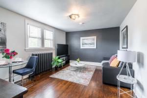 a living room with a couch and a table at Stylish 1BR Apartment - Heart of James South Hamilton in Hamilton +6 photos