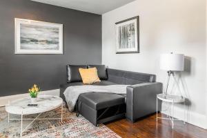 a living room with a couch and a table at Stylish 1BR Apartment - Heart of James South Hamilton in Hamilton