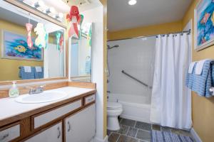 a bathroom with a sink and a shower and a toilet at Kailua Bay Resort 4-305 condo in Kailua-Kona