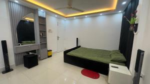 a small bedroom with a bed and a mirror at Avin House in Nabiganj