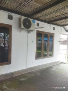 Un altavoz en el lateral de un edificio con ventanas. en Kasutapan homestay, en Kembangarum