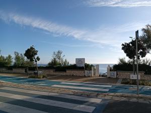 an empty street with a view of the ocean at Hotel Club Perla in Casalabate