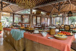 a buffet in a resort with food on a table at Vilangelim Eco-Pousada in Imbassai