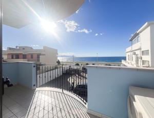 a balcony with a view of the ocean from a building at La Perla di Ponente in Milazzo